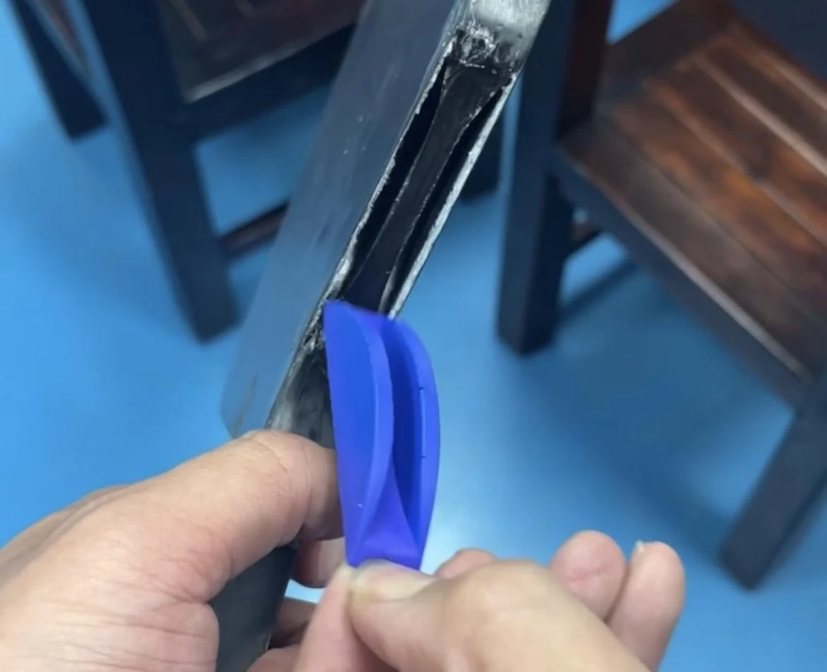 Hands checking a pickleball paddle construction detail