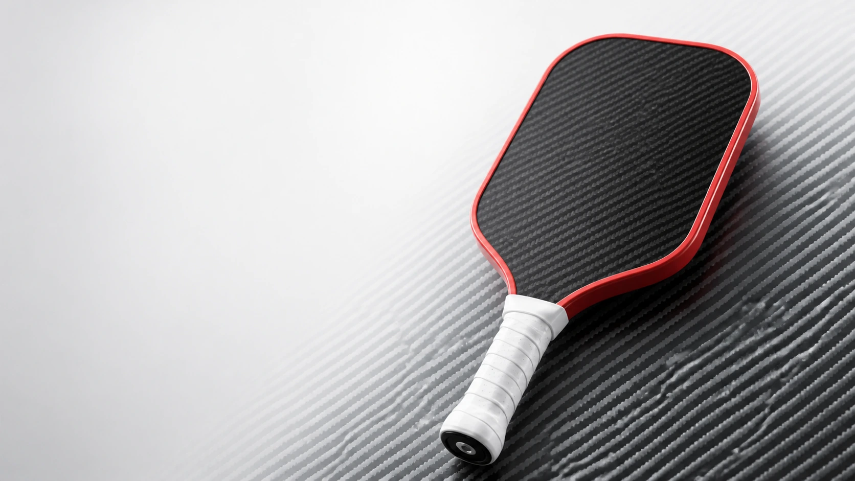 High-resolution carbon fiber pickleball paddle with red edge guard and white grip